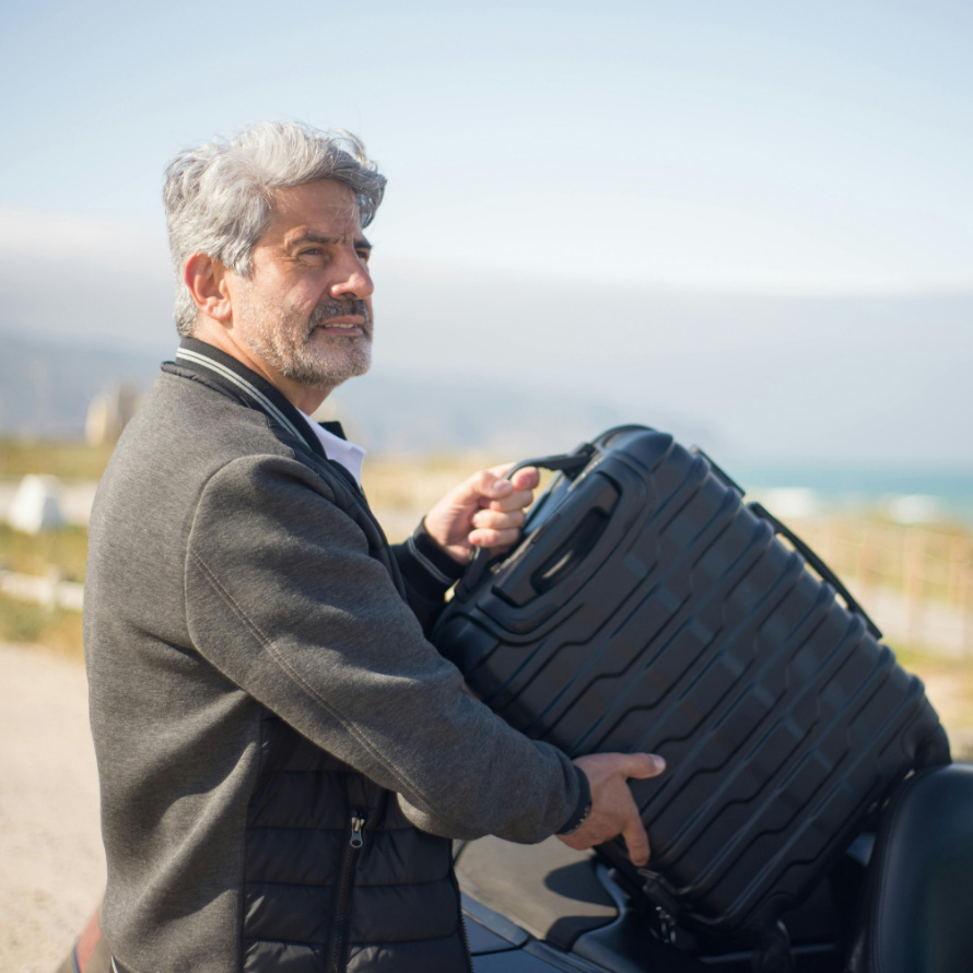 Business traveller loading his EV after staying at a hotel with EV chargers