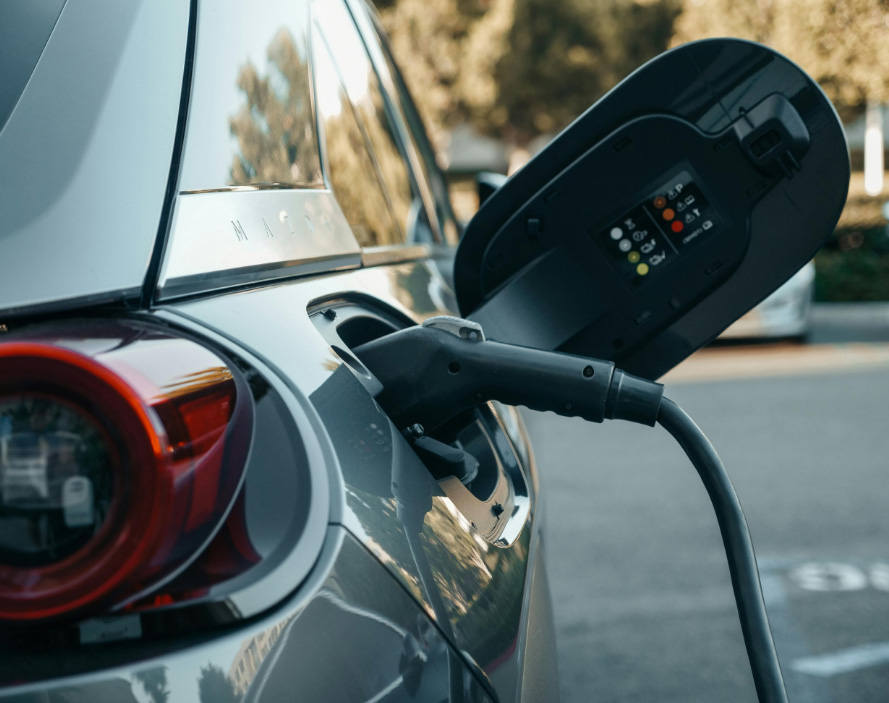 Grey EV plugged into our Optimus charger at a Holiday let